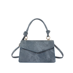 Deep blue denim handbag for women with knot handle detail and adjustable shoulder strap
