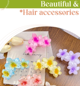 Detailed top view of large colorful plumeria hair claws in various gradient candy colors