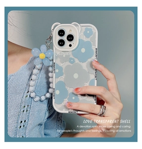 Detail of transparent iPhone case with blue flower patterns and matching beaded charm strap
