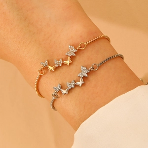 Detail of adjustable butterfly bracelet set with sparkling zircon in gold and silver finish