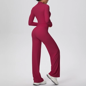 Three-piece yoga set featuring a magenta zip-up top and high-waisted flared pants