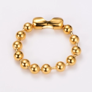 Close-up of a 18k gold plated stainless steel beaded ring with a wide curved top element