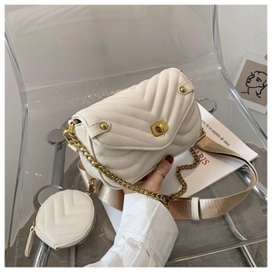 Close-up of cream quilted leather bag with gold twist lock and mini round coin purse