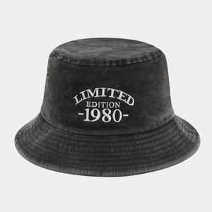 Close-up of white 1980 Limited Edition embroidery on charcoal grey washed denim bucket hat