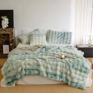 Close-up of mint green checkered faux fur blanket texture with thick plush fibers