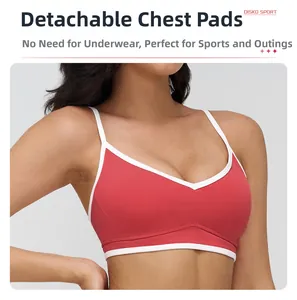 Detail of red and white sports bra featuring removable pads and high-stretch fabric