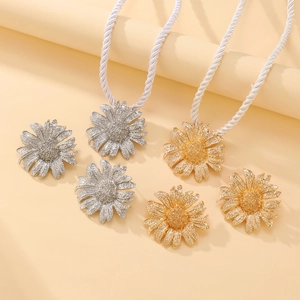 Sunflower shaped curtain tiebacks in gold and silver finish with woven rope ties