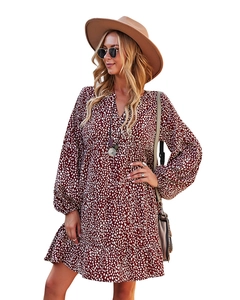 Detail of V-neck leopard print dress in deep red with ruffled hem and long sleeves