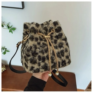 Stylish plush leopard print bucket bag with gold chain drawstrings and pearl accents