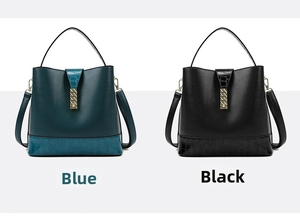 Detail of blue and black tote bags featuring embossed crocodile texture and gold hardware