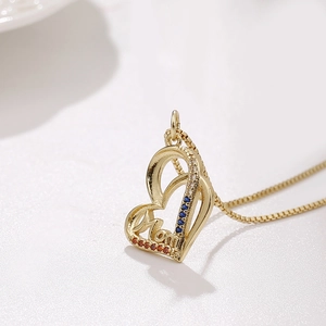 Golden heart necklace with MOM lettering and colorful zircon stones on white background