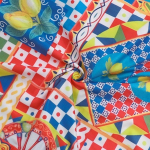 Close-up of Mediterranean lemon and tile print fabric with high knit texture detail