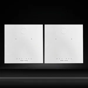 Minimalist white jewelry display cards with hanging holes for earrings and necklaces