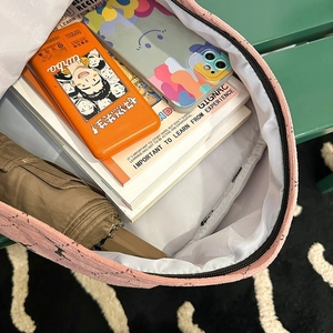 Internal view of pink school backpack showing spacious storage and inner pockets