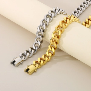Detail of 13mm gold and silver Cuban chain bracelets with secure box clasps