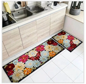 Detail of long and short kitchen mats with vibrant floral patterns on black background