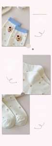 Detail view of cotton mid-calf socks showing elastic cuff, heel shape, and bear embroidery