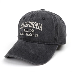 Close-up of white California embroidery on washed charcoal denim baseball cap texture