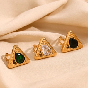 Detailed macro of 18K gold plated triangle rings with teardrop gemstones on silk