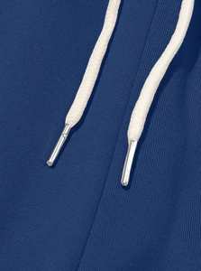 Macro detail of dark blue fleece fabric with beige woven drawstring and silver metal tips
