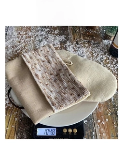 Detail shot of beige fabric weight measurement showing 104.8g for Christmas gift bag