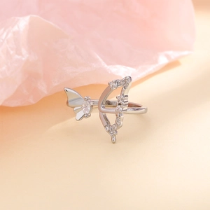Macro shot of silver bow and butterfly ring with sparkling cubic zirconia crystals