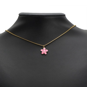 Gold necklace with pink enamel flower pendant and pearl center on a black mannequin