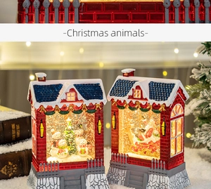 Macro view of Christmas house snow globes with Santa and snowman scenes and warm LED lights