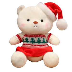 Cute white Christmas teddy bear plush toy wearing a red hat and knit sweater on white background
