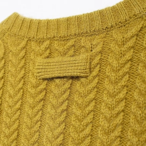 Retro mustard yellow knit cardigan with round neck and detailed cable stitch texture
