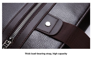Detail of lychee pattern leather briefcase with silver zipper and reinforced rivets