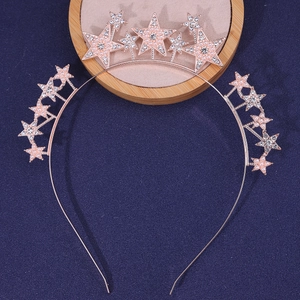 Macro detail of rose gold bridal headband with rhinestones and faux pearls stars