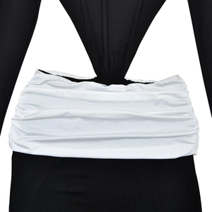 Detail of the high-waisted black and white patchwork dress with pleated waist design