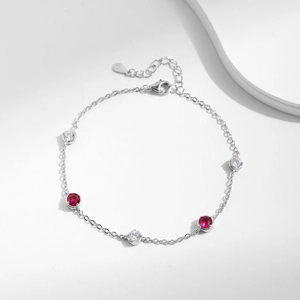 Elegant S925 sterling silver bracelet with red and clear gemstones on white background