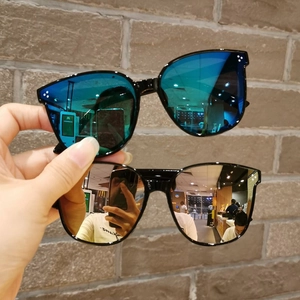 Detail of square children's sunglasses with silver and blue mirrored lenses and rivets