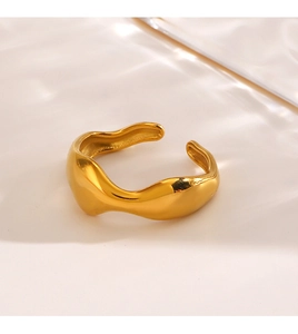 Detailed view of an irregular wavy gold ring with an adjustable open design