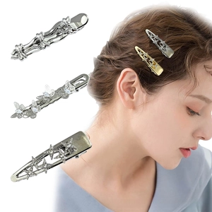 Detailed macro view of silver butterfly and star hair clips with shimmering rhinestones