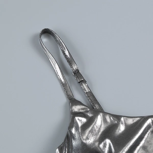 Detail of adjustable silver metallic strap with polished coating on a slim dress