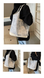 Detailed views of a light blue denim tote bag with white bow patterns and cream leather trim