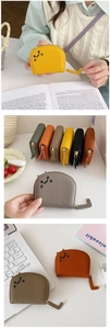 Detailed view of cat-shaped coin purses with embroidery and tail-shaped zipper pulls