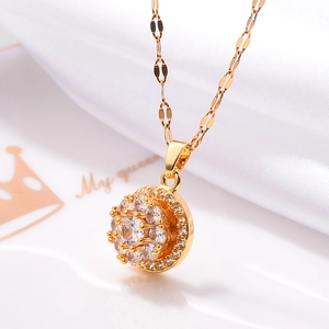 Close-up of 18K rose gold plated pendant with sparkling cubic zirconia on silk fabric