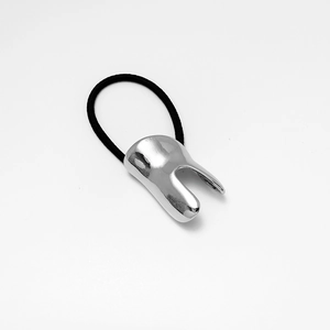 Detailed close-up of a black thick elastic hair tie with a U-shaped silver alloy buckle