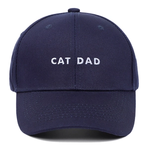 Close-up of CAT DAD white embroidery on navy cotton twill baseball cap with stitching