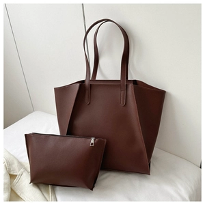 Detail view of the deep brown leather tote bag with matching zippered inner pouch