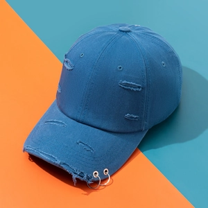 Distressed denim baseball cap with metallic rings and vintage ripped details for unisex wear