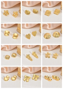 Macro view of various 18K gold-plated stainless steel earrings in floral and heart shapes