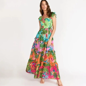 Close-up of bohemian tiered maxi dress with tropical floral print and ruffle sleeves
