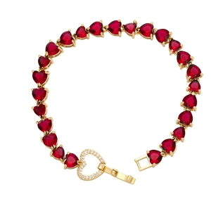 Luxurious gold heart bracelet with red zircon stones and crystal clasp on white background