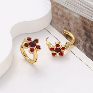 Detail of 18k gold plated stainless steel earrings with red floral crystal inlay