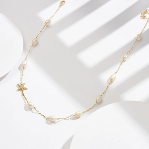 Detail of S925 silver necklace with sea star pendant and white freshwater pearls